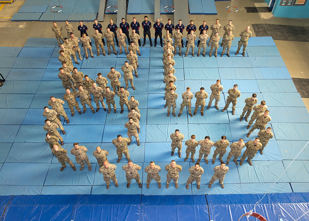 Members of Airborne Delivery Wing stand formed into the number 85.